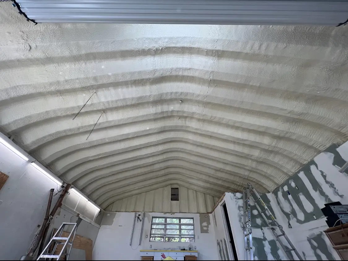 Spray polyurethane foam applied to the underside of a metal roof deck in Bayonne
